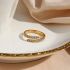 Gouden gedraaide lus met verstelbare ring met zirkonen